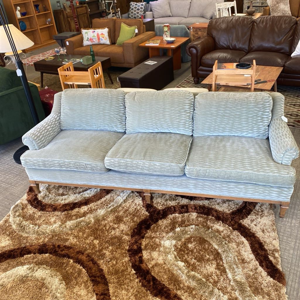 Light gray sofa in a room with other furniture and decor