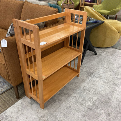 Wooden bookshelf in a room with furniture and decor