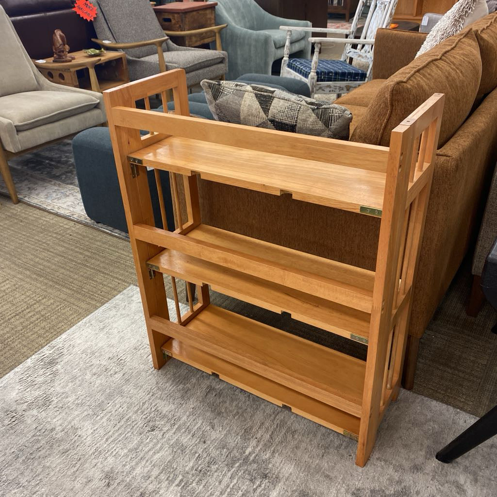 Wooden bookshelf in a room with furniture and decor