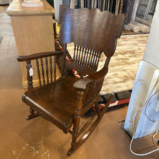 Wooden rocking chair in a storage or warehouse setting