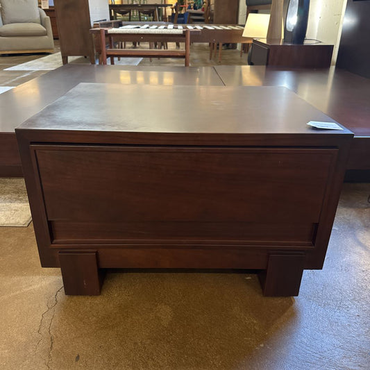 Wooden desk with a drawer in a furniture store setting