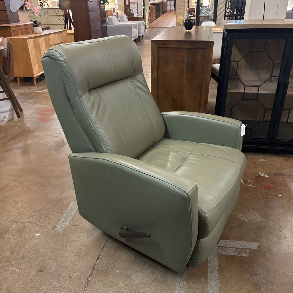 Green leather recliner chair in a showroom setting