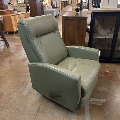 Green leather recliner chair in a showroom setting