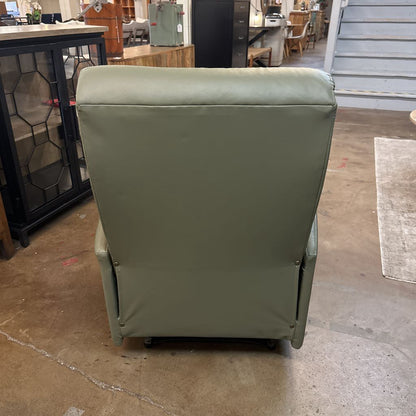 Green refrigerator with a cover in an indoor setting