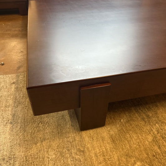 Dark wooden desk on a carpeted floor