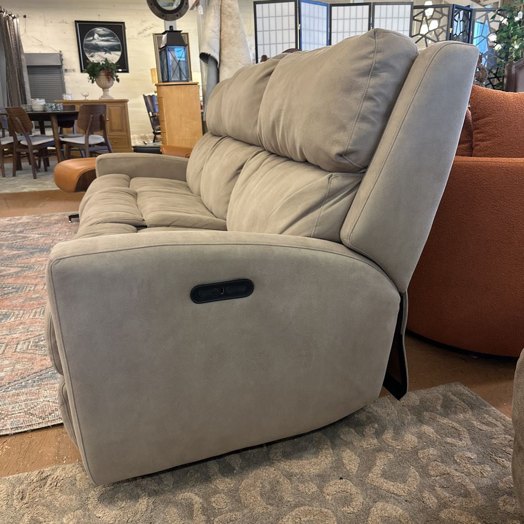 Gray recliner sofa in a room with furniture and decor.