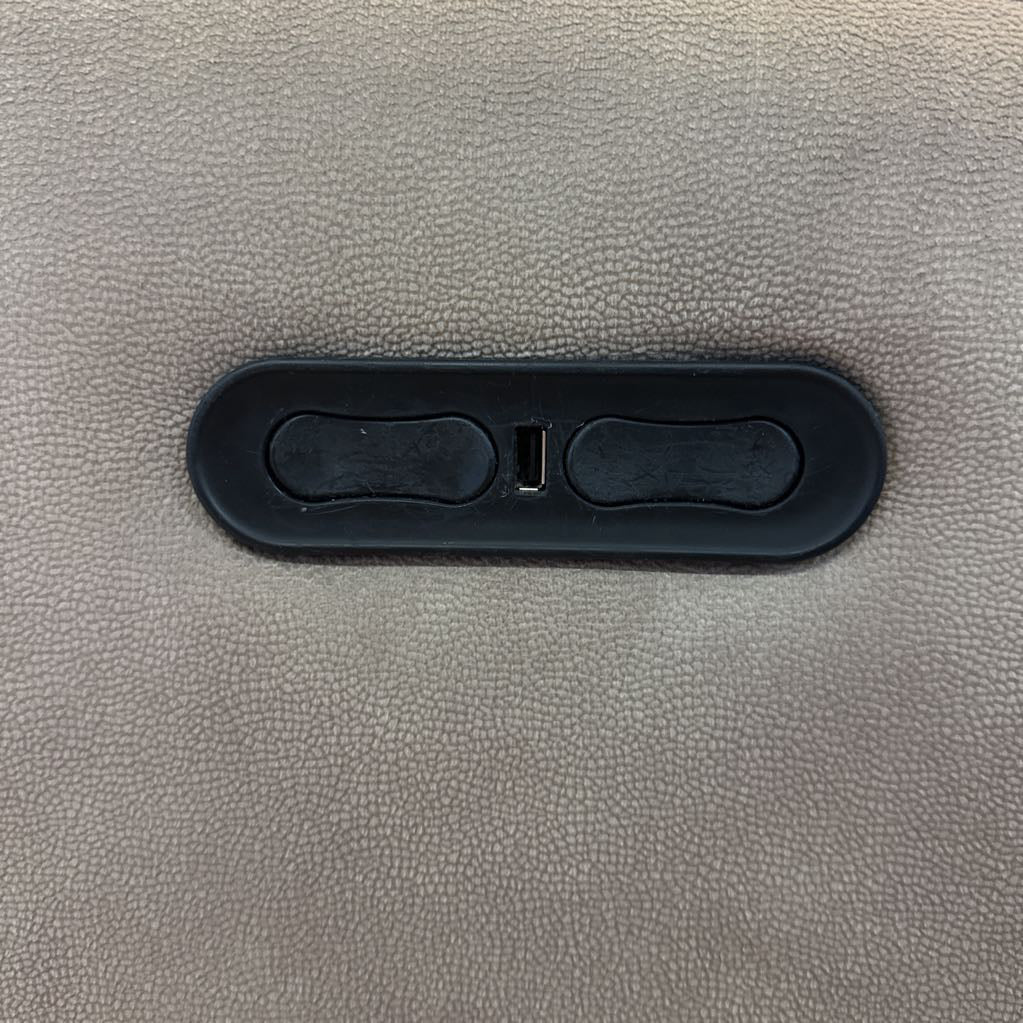 Close-up of a gray textured surface with a black plastic component.