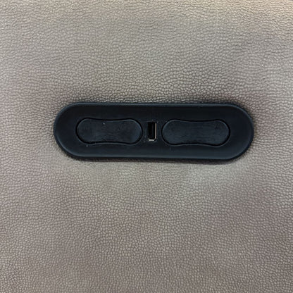 Close-up of a gray textured surface with a black plastic component.