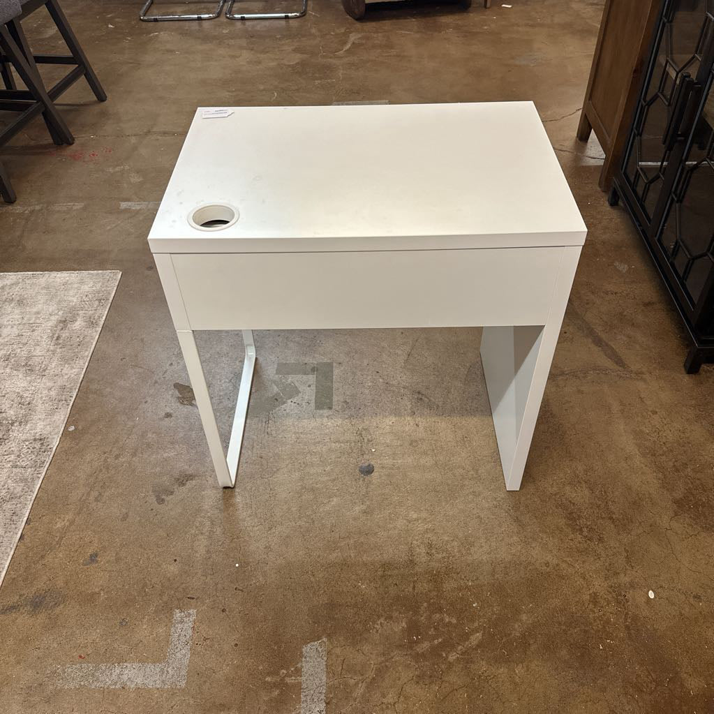 White rectangular table on a brown concrete floor