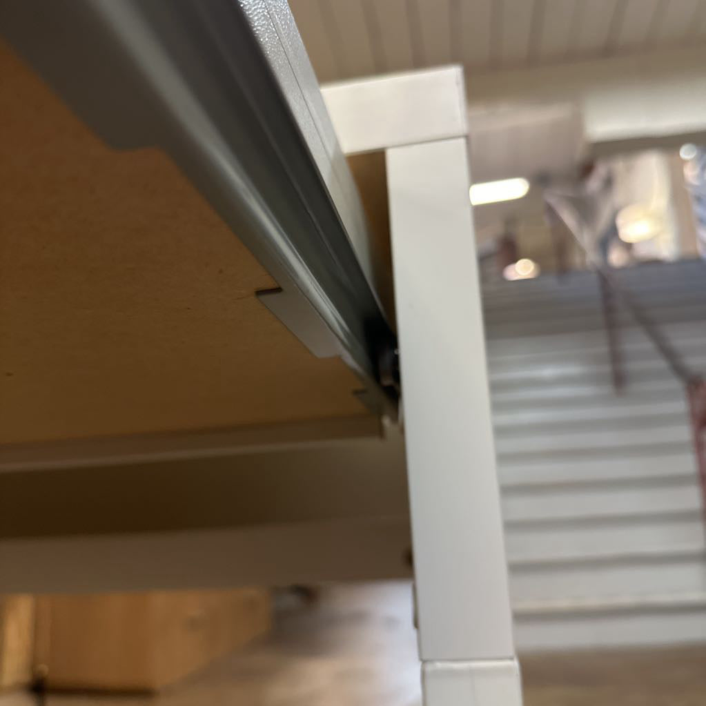 Close-up of a metal frame with a blurred indoor background