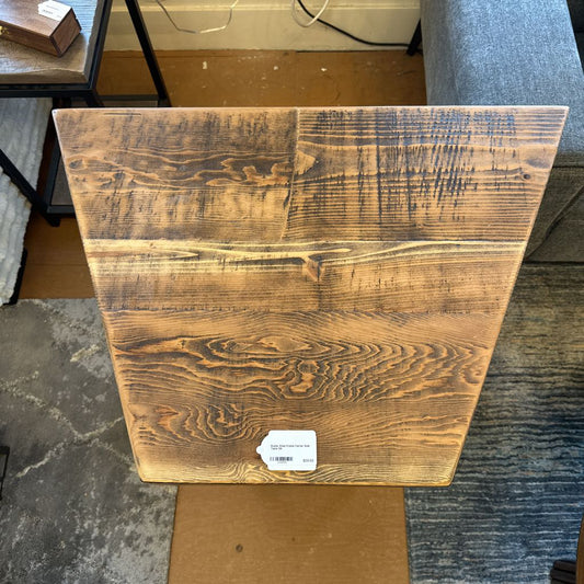 Wooden panel with a visible label on a floor