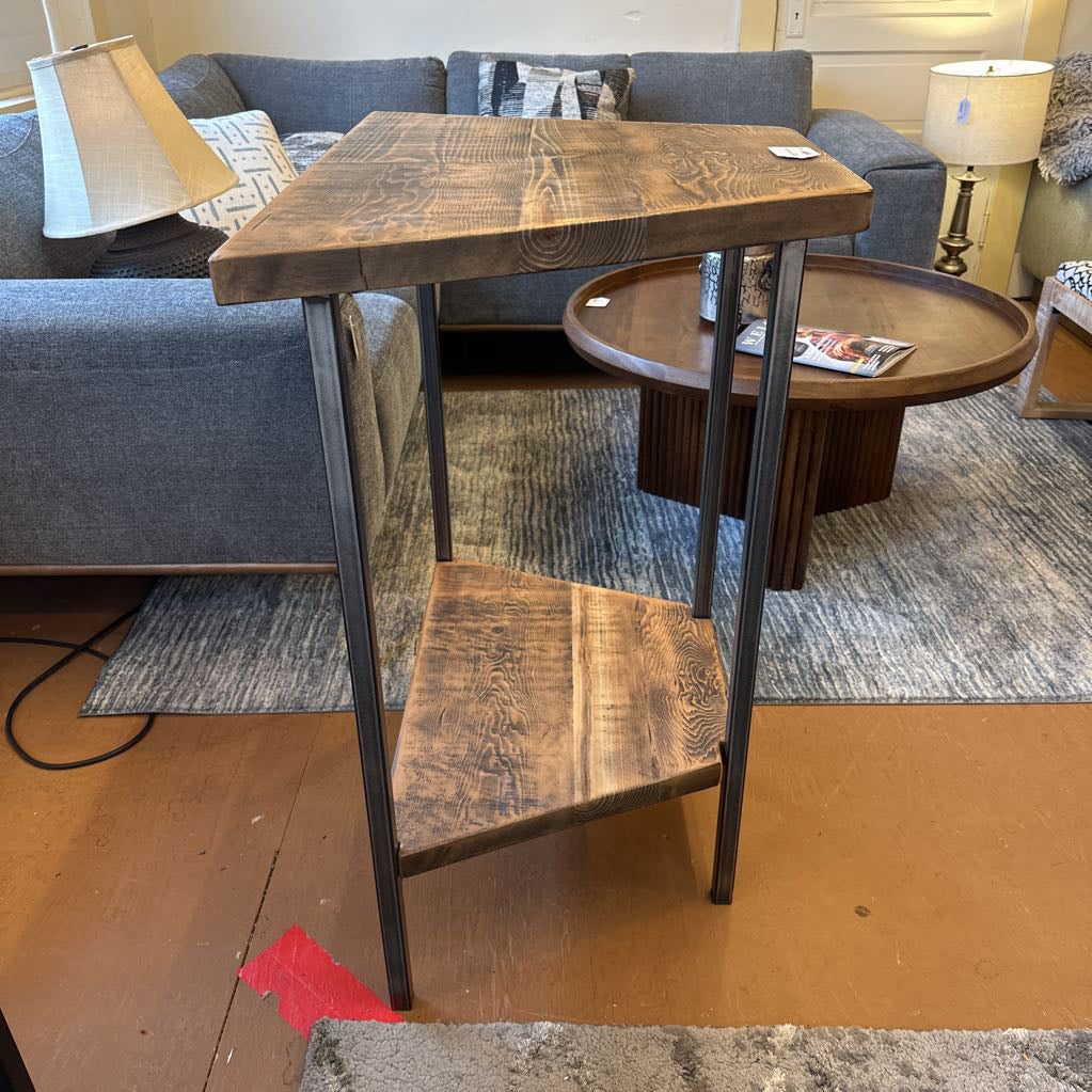Wooden side table with metal legs in a living room setting