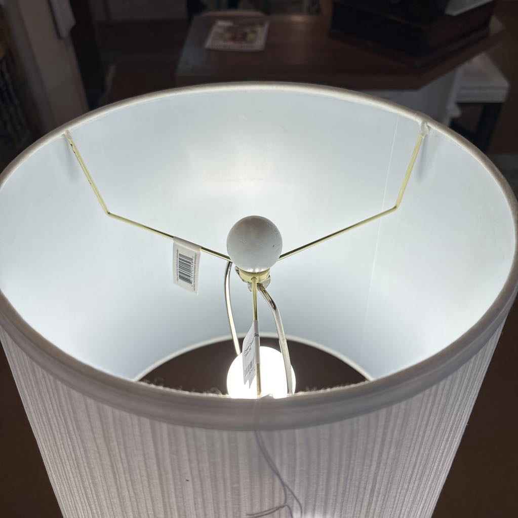 Close-up of a lamp with a white shade and base.