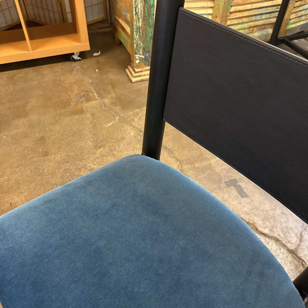 Blue chair seat with black backrest in an indoor setting