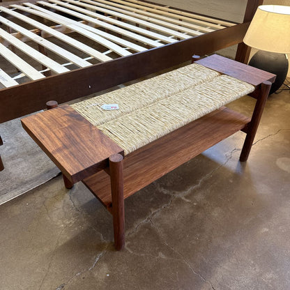 Wooden bench with woven seat in a room setting