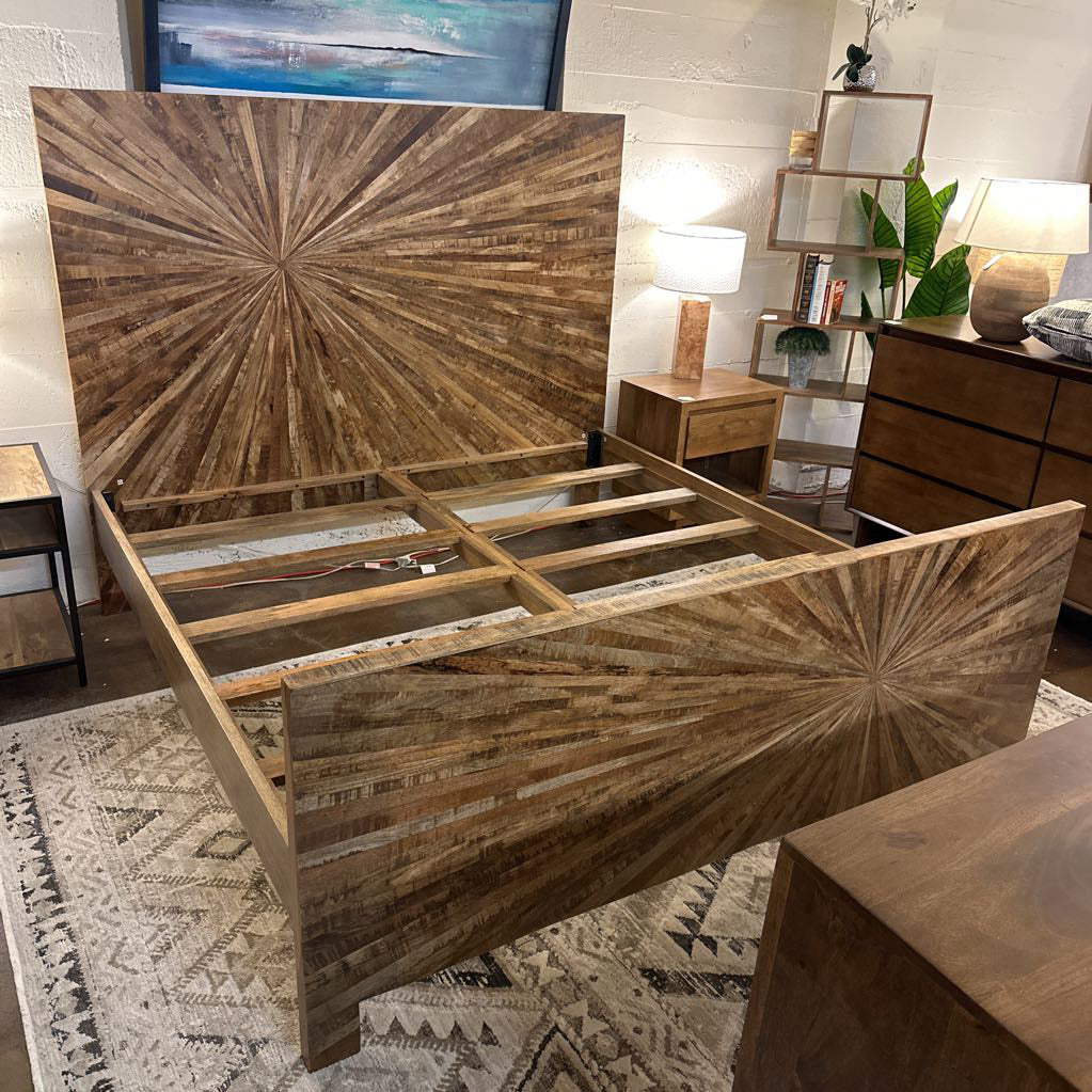 Wooden bed frame with starburst design in a bedroom setting