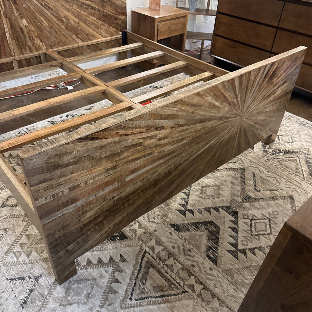 Wooden furniture piece with geometric pattern on a patterned rug