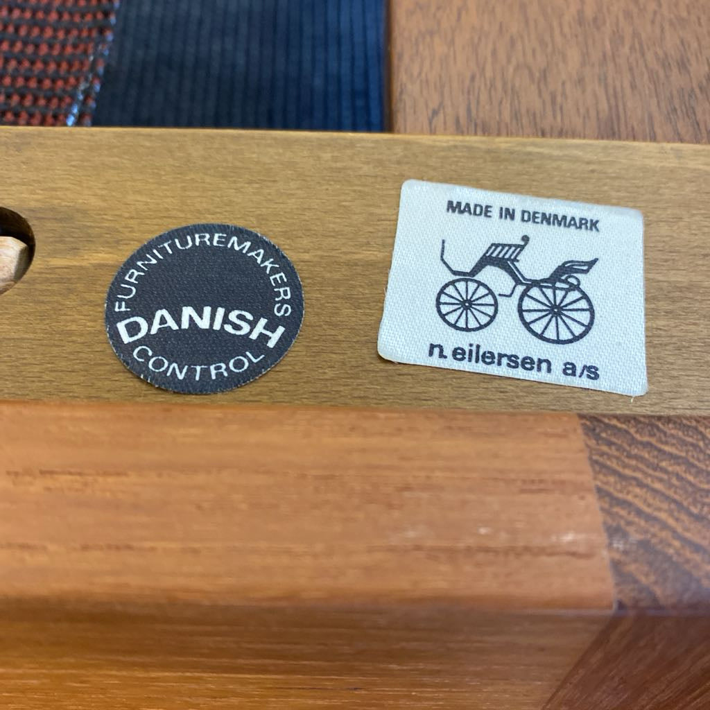 Wooden surface with 'Danish Furniture Makers Control' and 'Made in Denmark' labels.