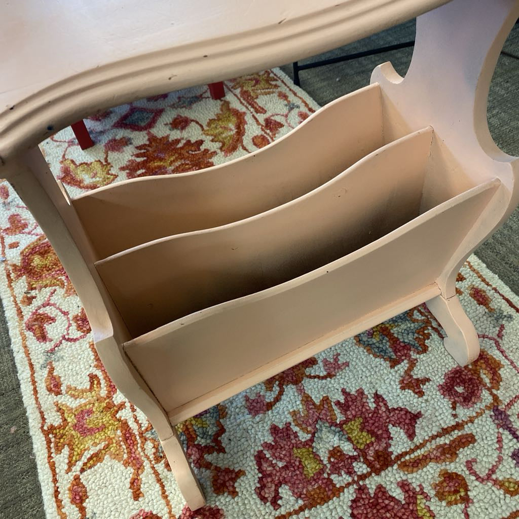 Beige magazine rack on a colorful floral rug