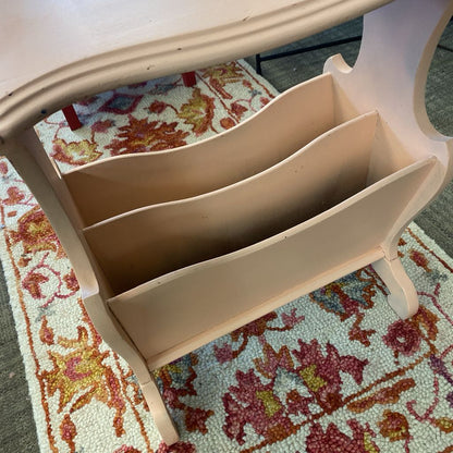 Beige magazine rack on a colorful floral rug