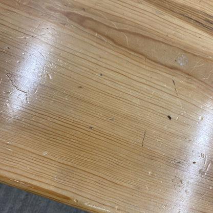 Close-up of a wooden surface with visible grain and imperfections