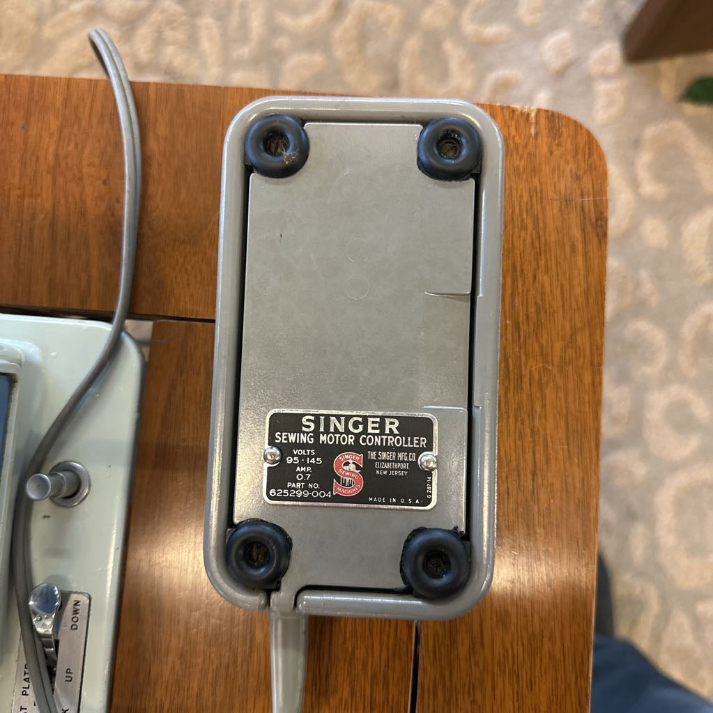 Singer sewing motor controller on a wooden surface