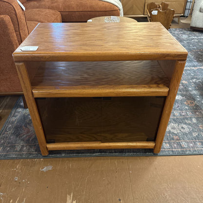 Wooden side table with a shelf in a furniture store setting