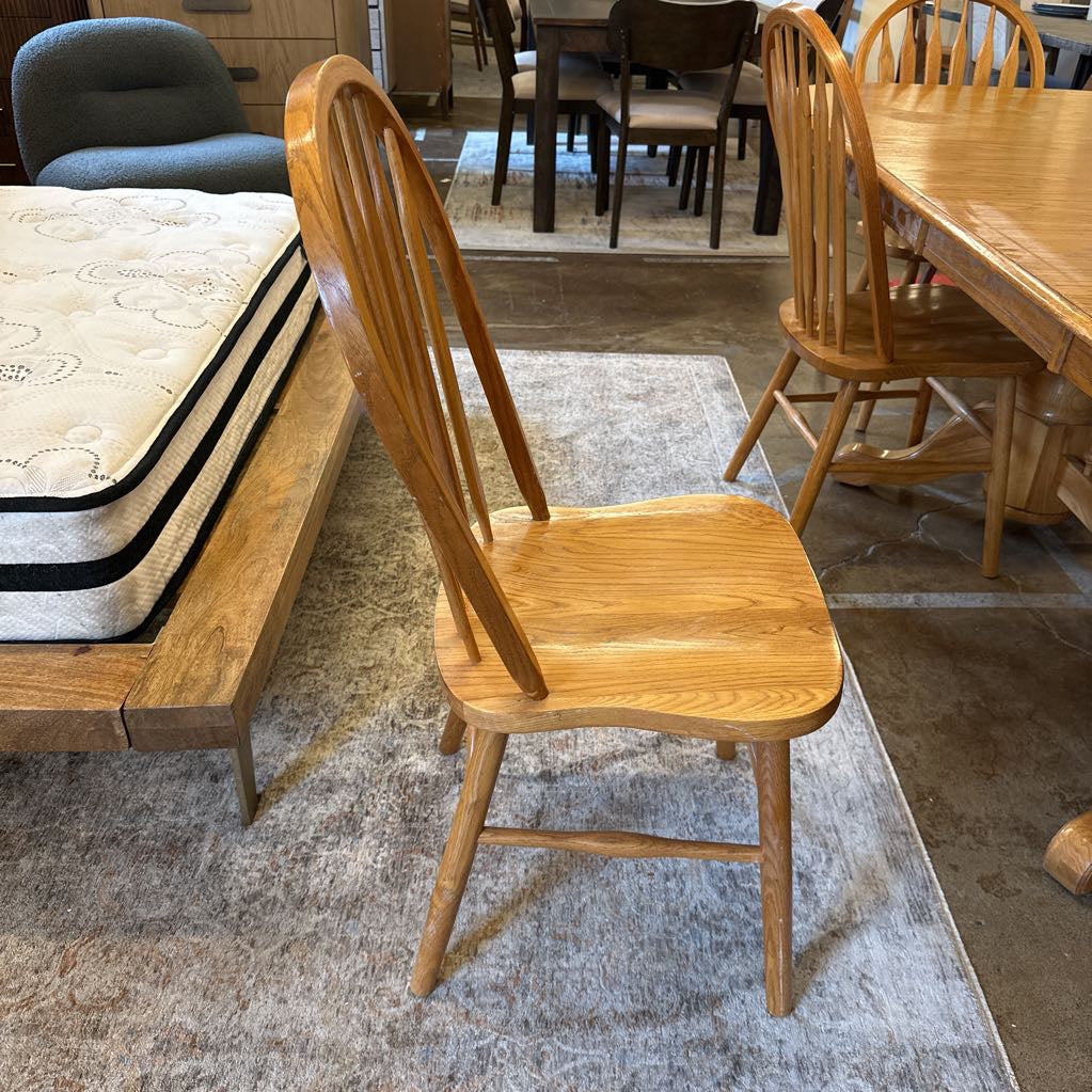Wooden chair in a furniture store with mattresses and tables in the background