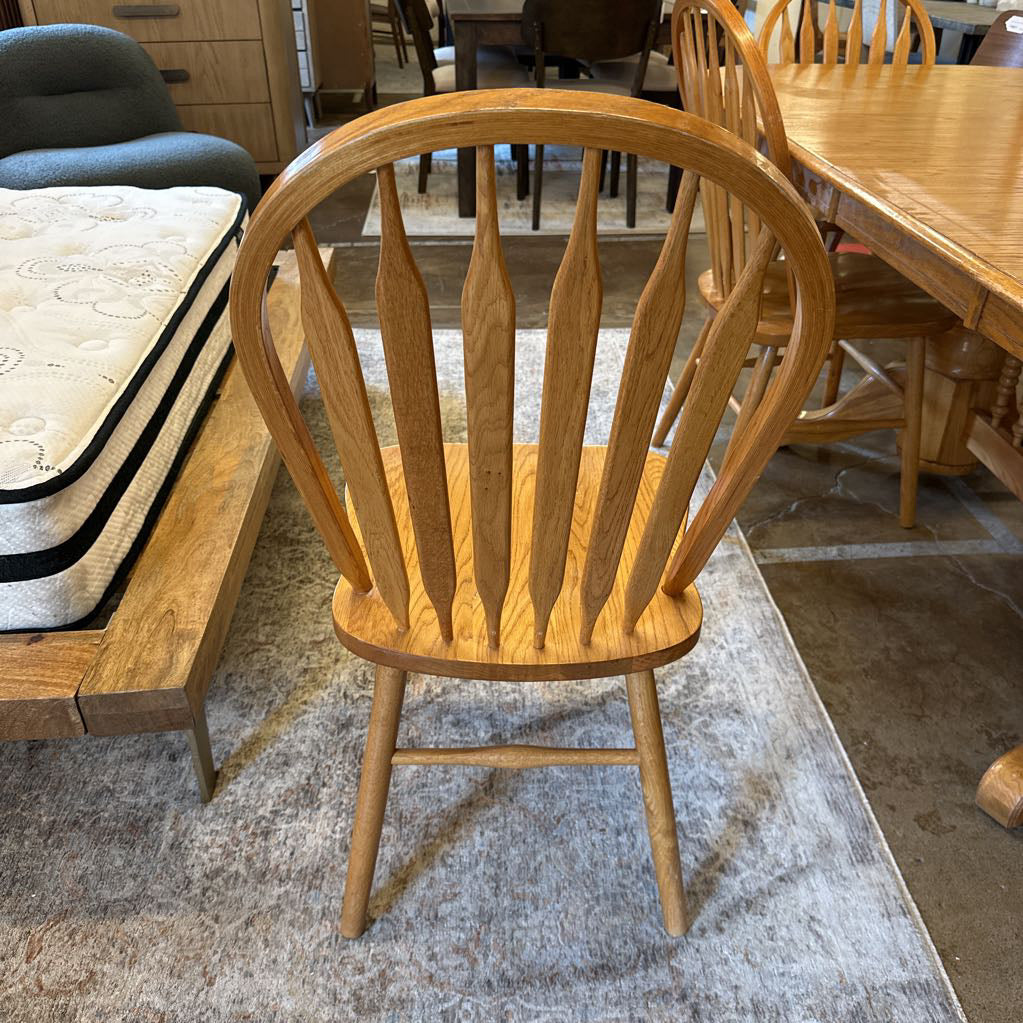 Wooden chair in a room with furniture and flooring visible