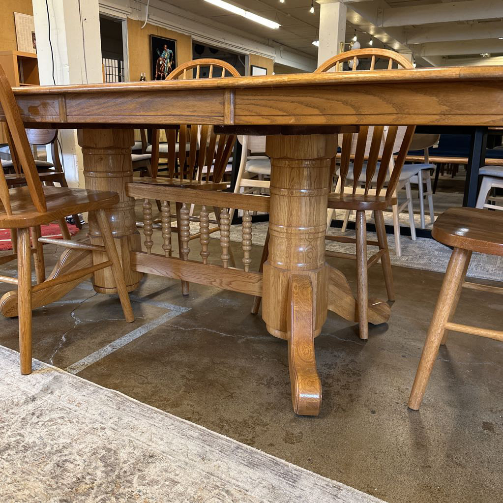 Wooden dining table with chairs in a store setting