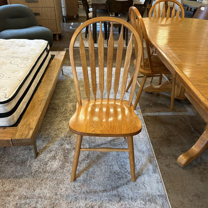 Wooden chair in a furniture store with mattresses and tables in the background