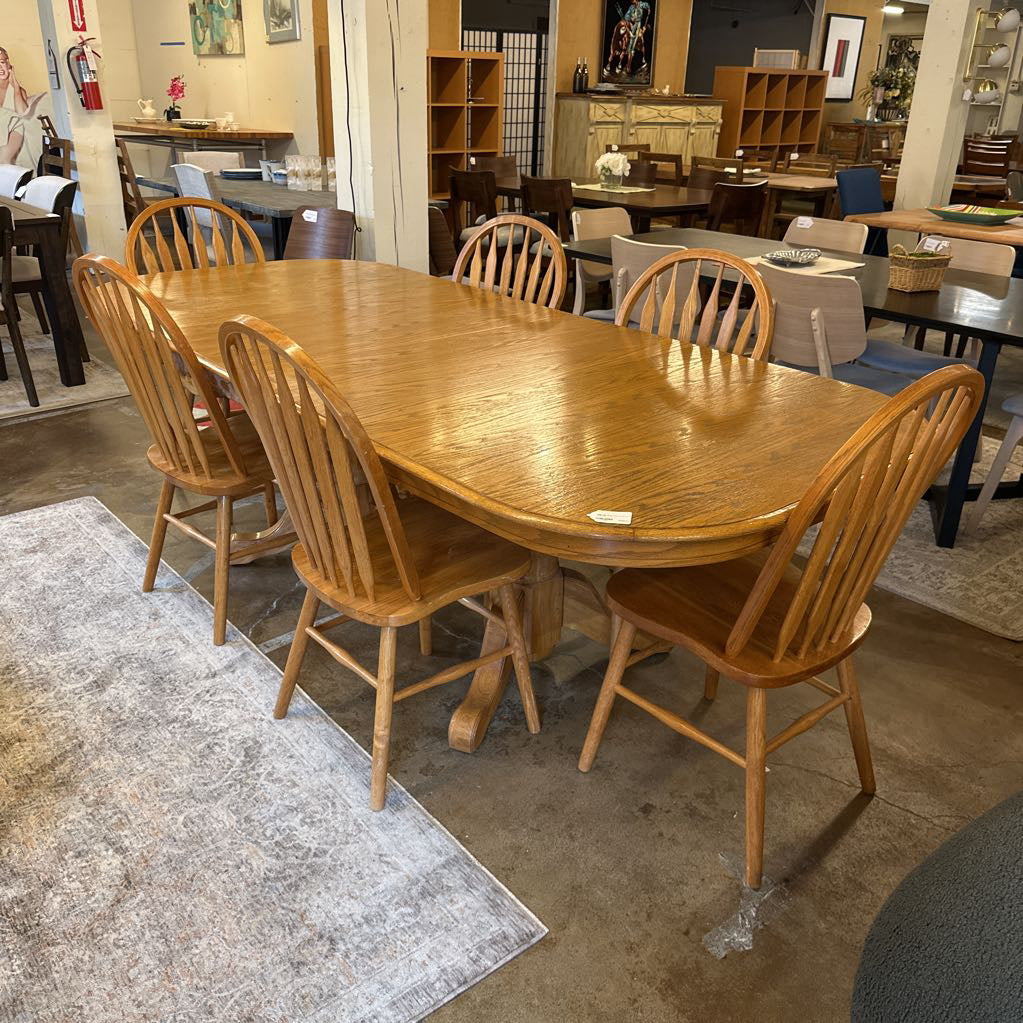 Wooden dining table with chairs in a showroom setting