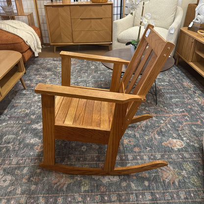 Wooden rocking chair in a room with furniture and decor