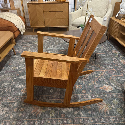 Wooden rocking chair in a room with furniture and decor