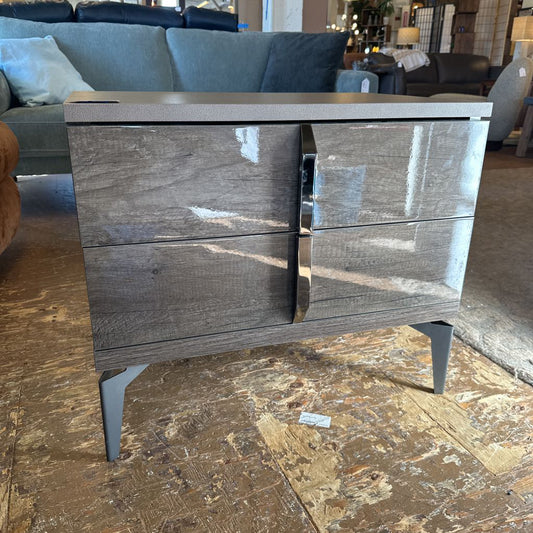 Wooden dresser with marble-like finish on a stone floor