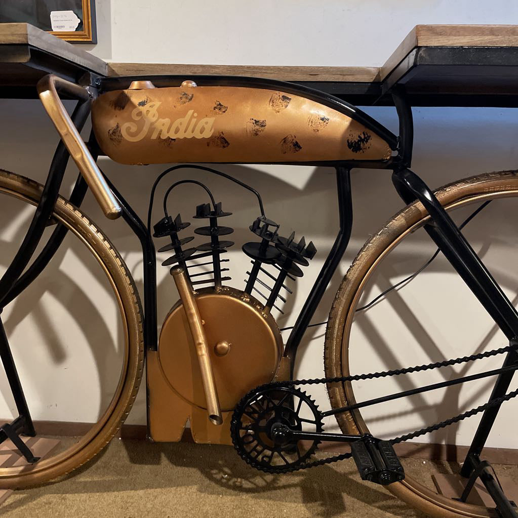 Vintage-style bicycle with 'India' branding on a wooden surface.