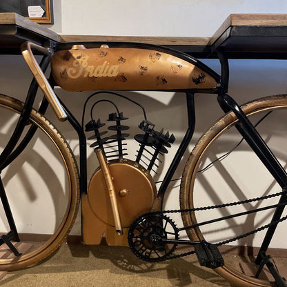 Vintage-style bicycle with 'India' branding on a wooden surface.