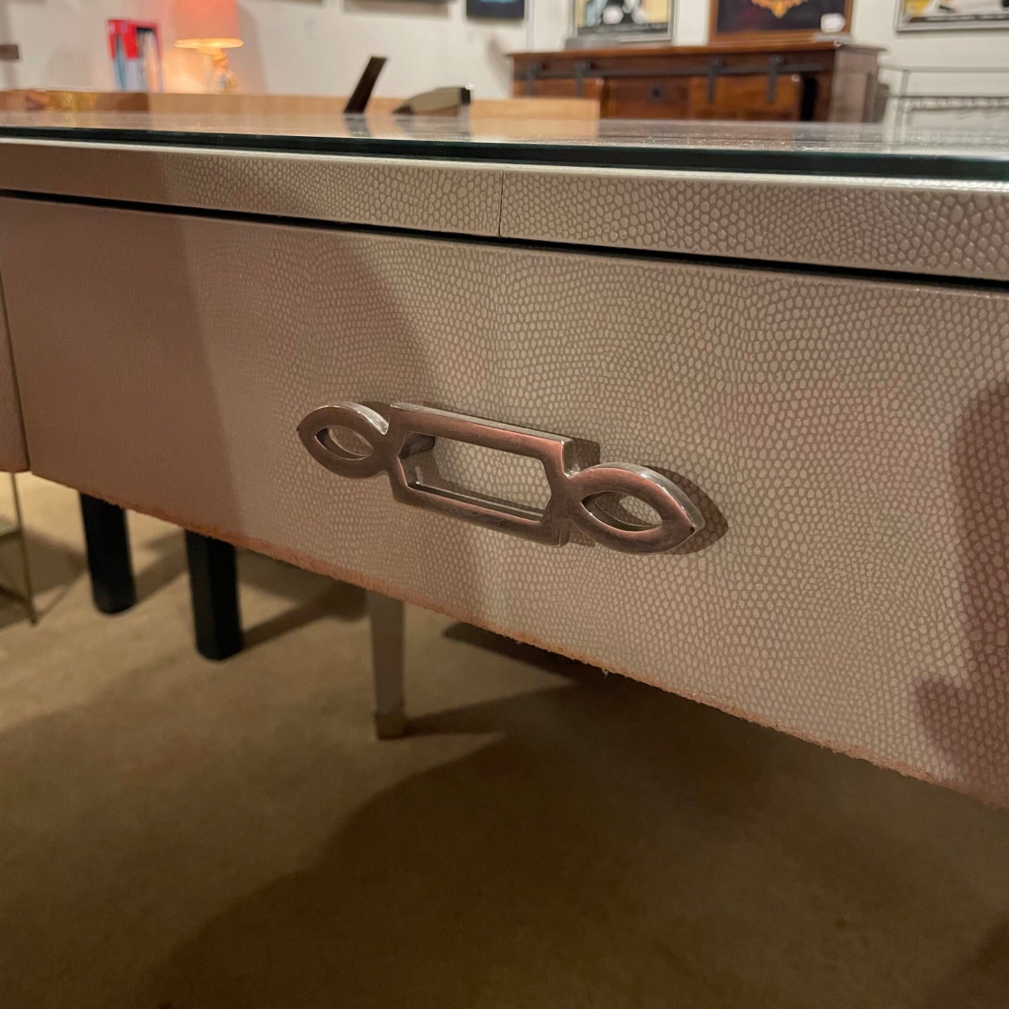 Close-up of a textured drawer with a metallic handle in an indoor setting.