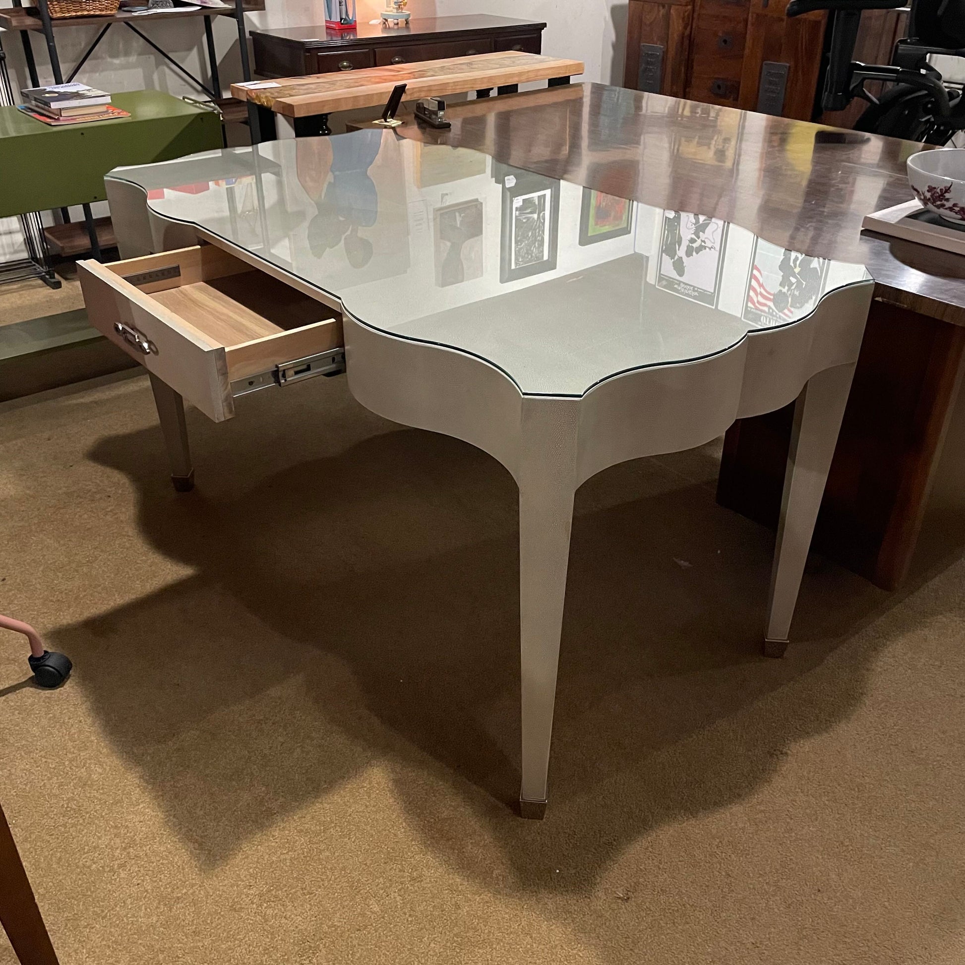 White dining table with a drawer in a showroom setting