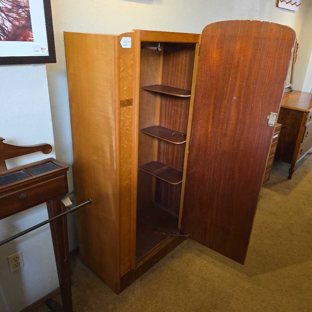 Wooden wardrobe with open doors in a room setting