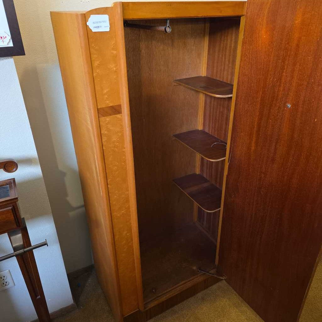 Wooden wardrobe with open doors showing shelves in a room setting.