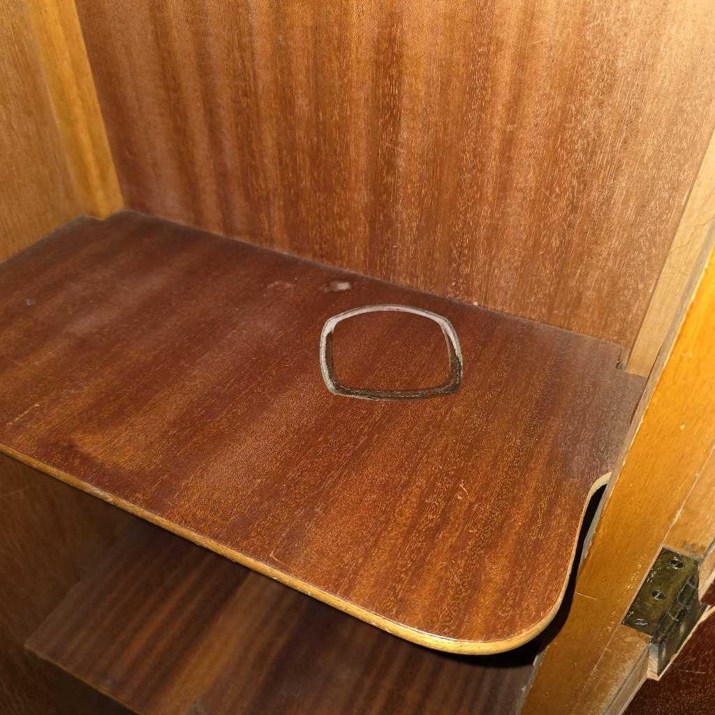 Wooden shelf with a small cutout in a wooden cabinet