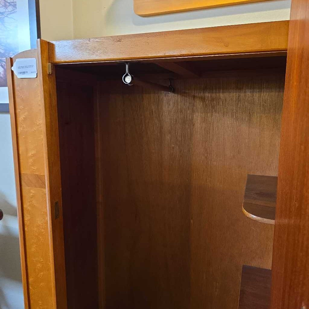 Wooden wardrobe with open door showing empty interior