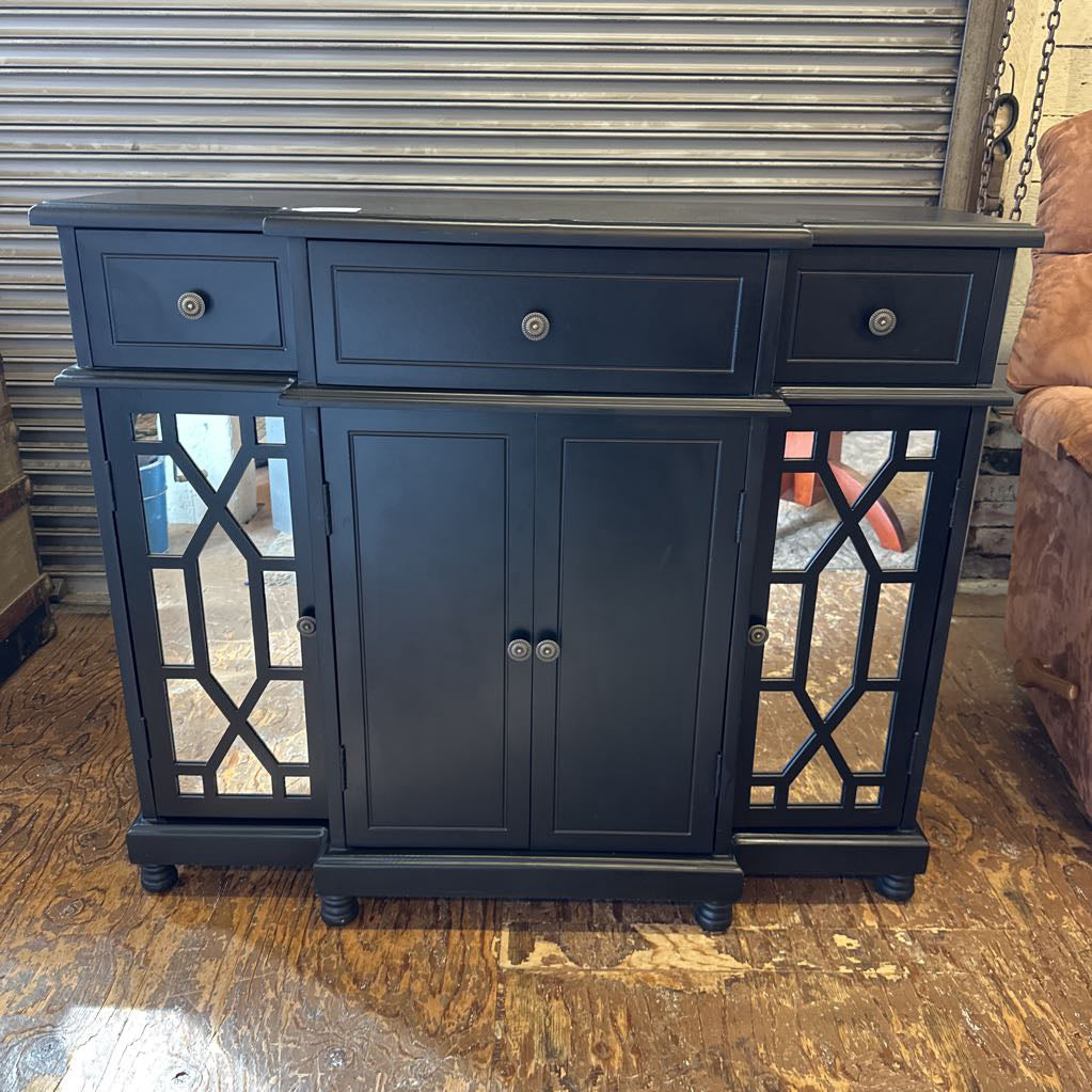 Dark blue cabinet with mirror panels on a wooden floor.