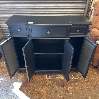 Blue cabinet with open doors on a wooden floor