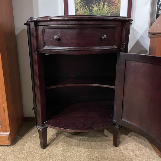 Wooden corner cabinet with open door in a room setting