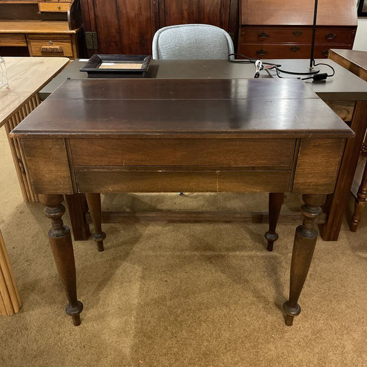 Wooden desk with a chair in an indoor setting