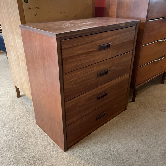 Wooden dresser with three drawers on a carpeted floor