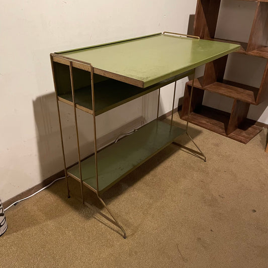 Two metal shelves with green tops in a room setting.