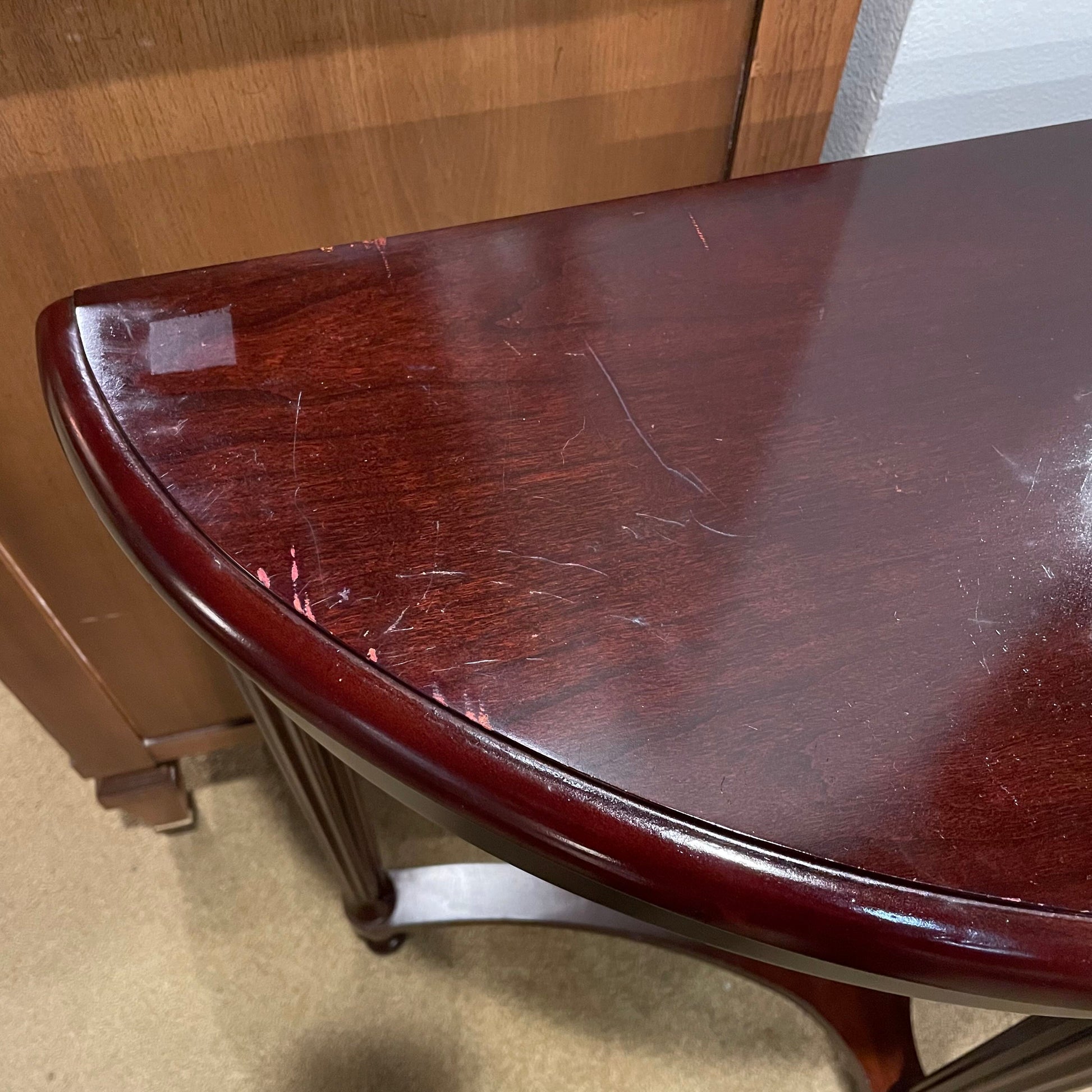 Wooden table with visible scratches in a room setting